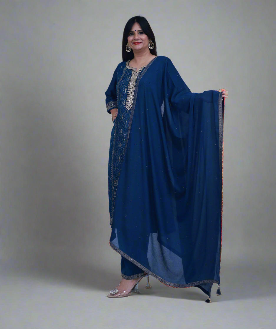 Woman wearing a blue traditional outfit with a matching dupatta on a white background