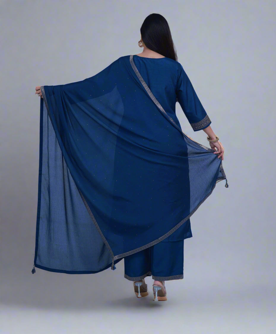 Woman wearing a blue traditional outfit with a matching dupatta on a light gray background