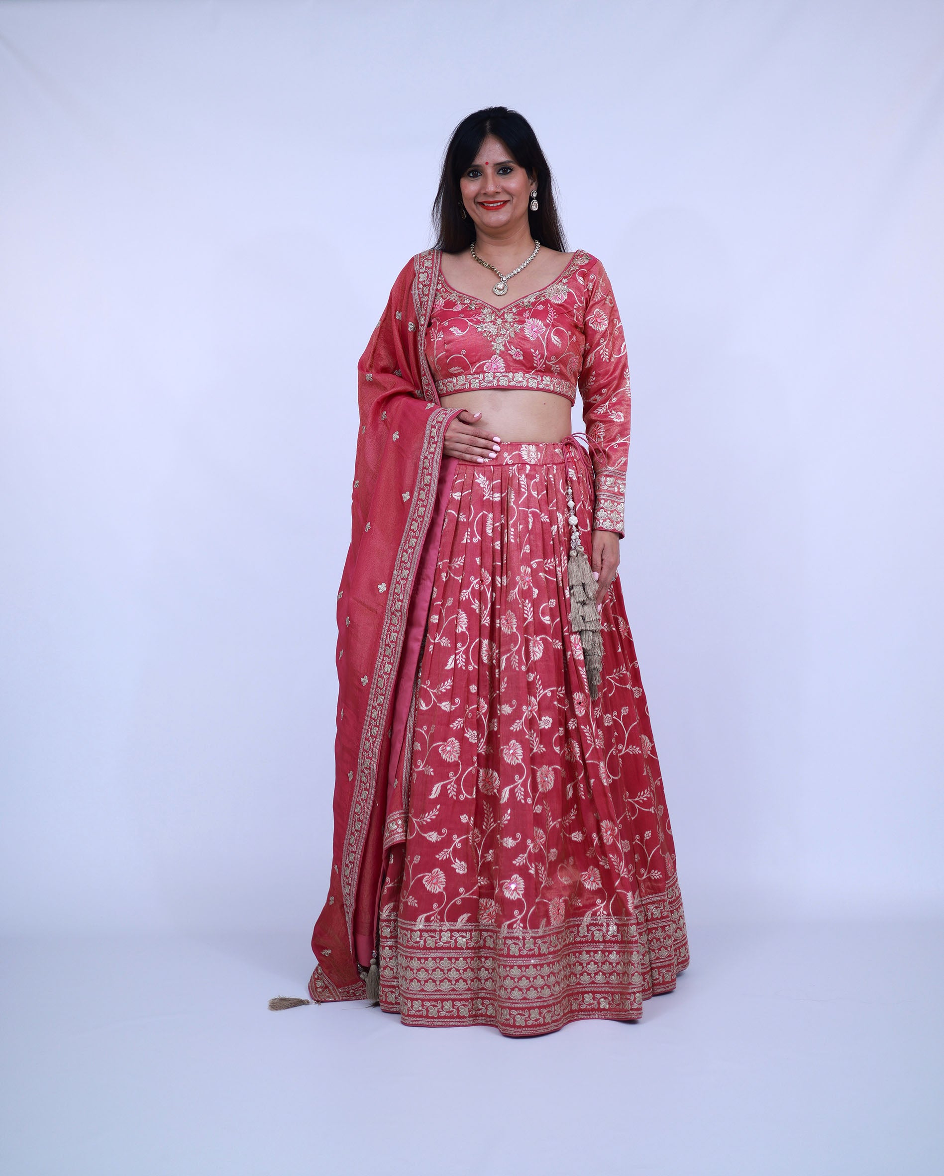 Woman wearing a red floral traditional outfit on a white background